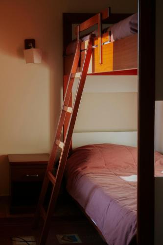a ladder to a bunk bed in a room at Le Cedrus Hotel in Al Arz