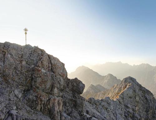 a cross on the top of a rocky mountain at Romantik Alpenhotel Waxenstein in Grainau