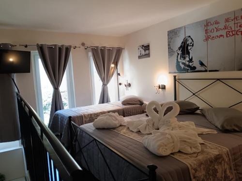 two beds with towels on them in a bedroom at Exclusive Loft degli Artisti in Florence