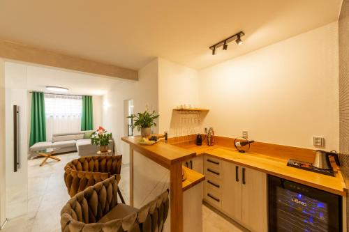 a kitchen and living room with a counter and chairs at Bohemia Inn Hotel in Turnov