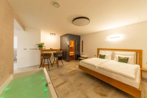 a bedroom with a bed and a bath tub at Bohemia Inn Hotel in Turnov