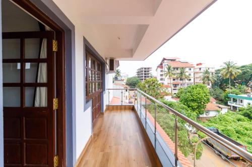 a balcony with a door and a view of a city at Casa Quina in Panaji