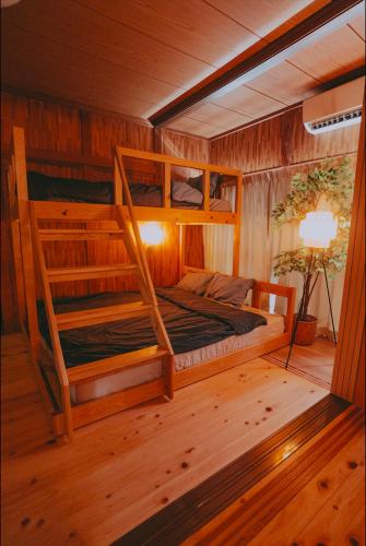 a bedroom with two bunk beds in a cabin at NorthStar Sea Breeze Holiday Home in Shimoda