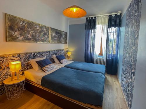una camera da letto con un letto grande con lenzuola blu di Vila nostra familha a Vallon-Pont-dʼArc