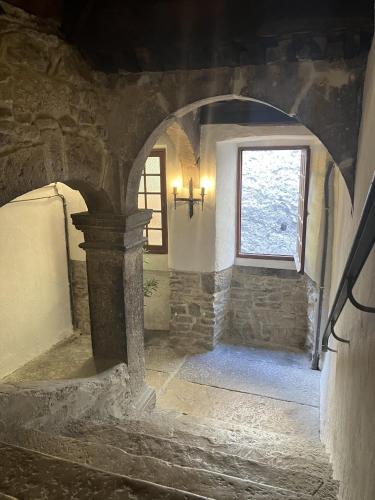 a stone hallway with a window in a building at Apartment Centre Historic in Marvejols