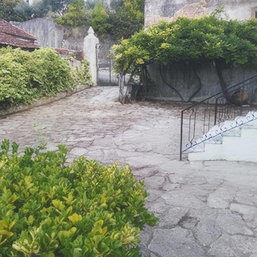 a stone walkway with plants and a stair case at Meio Country House in Alcanede