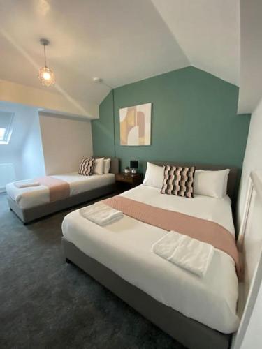 a hotel room with two beds in a room at 3-Bed House Near M1 & Meadowhall with Free Parking in Sheffield