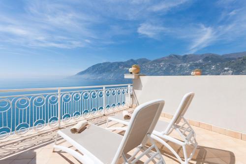a balcony with chairs and a view of the ocean at Hotel Club Due Torri in Maiori