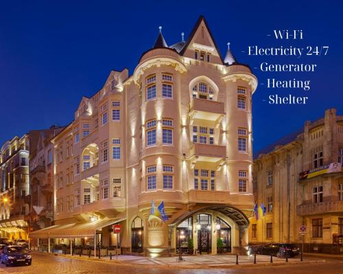 a large building in a city at night at Hotel Atlas Deluxe in Lviv
