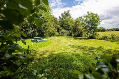 a park bench sitting in the middle of a field at Four bed barn conversion Junction 37 38 M1 in Barnsley