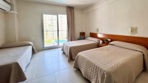 Postel nebo postele na pokoji v ubytování Hotel Safari
