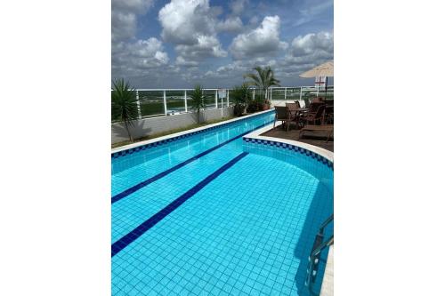 a swimming pool with a view of the ocean at Studio Sublime West Flat Mossoró in Mossoró