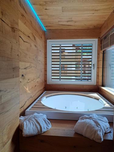 a large bath tub in a room with a window at Villa Miryam in Ponte di Legno