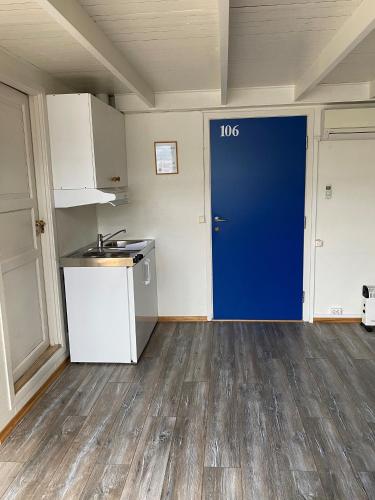 a kitchen with a blue door in a room at Hotel Svartisen in Mo i Rana
