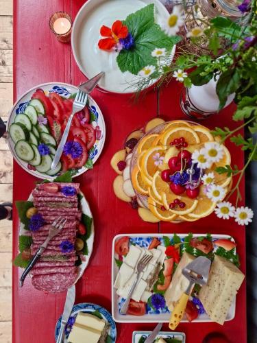 a red table with plates of food on it at Eco Camping De Helleborus in Groningen