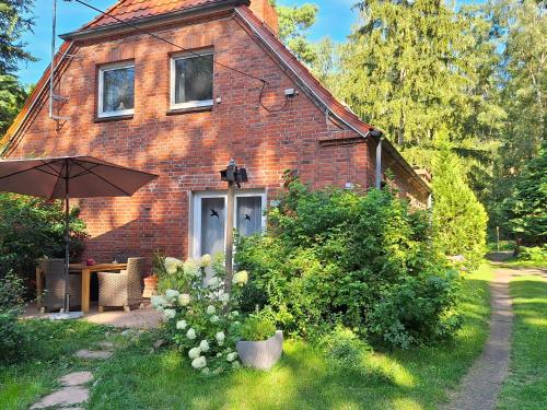 a brick house with an umbrella in front of it at Landhaus Dobbin in Dobbertin