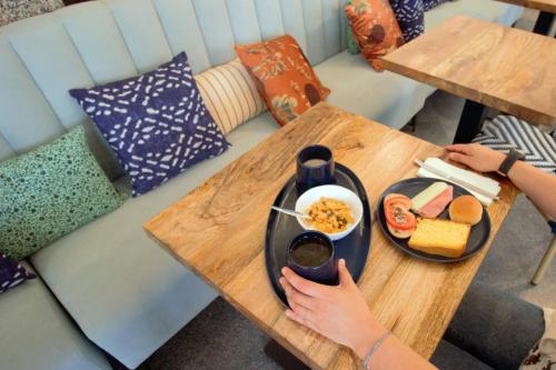 a person sitting at a table with a plate of food at WOT Costa da Caparica Soul in Costa da Caparica