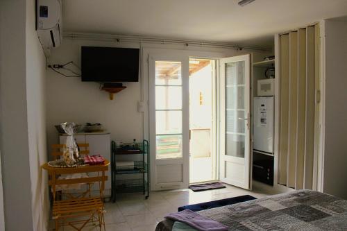 a room with a bed and a television on the wall at MER & SOLEIL in Morsiglia