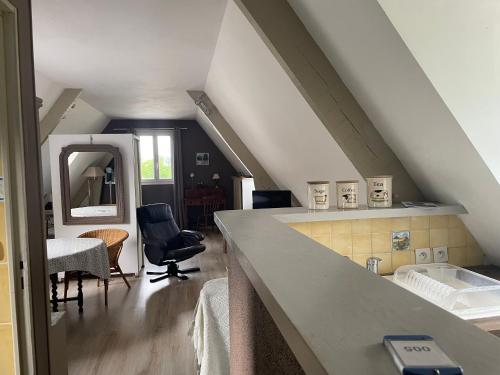 a attic room with a sink and a mirror at Apple garden in Victot-Pontfol
