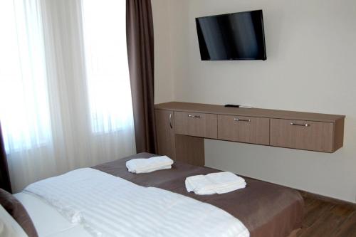 a bedroom with a bed with two towels on it at M70 Panzió Muraszemenye in Muraszemenye