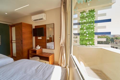 a bedroom with a bed and a tub and a window at prestige pyramids INN in Cairo