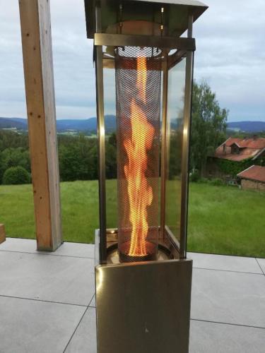 a fire in a cage on a patio at Rabenstein Suiten in Zwiesel