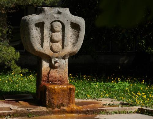 a stone monument sitting on the side of a sidewalk at Hotel Palace - KÚPELE SLIAČ in Sliač