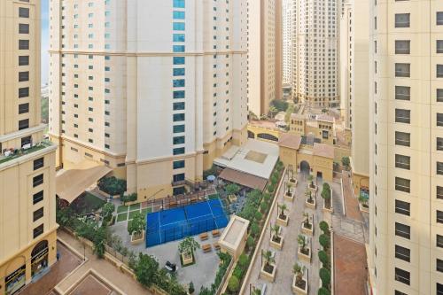 an overhead view of a city with tall buildings at La Buena Vida Holiday Homes - Modern, Luxe & Spacious 4-Bed, Full Kitchen, near to Beach, Tram & Marina in Dubai