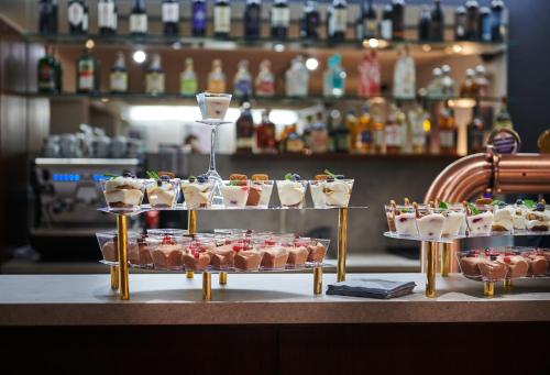 a display of desserts on a table in a bar at Hotel Palace - KÚPELE SLIAČ in Sliač