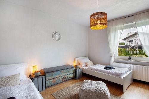 a bedroom with a bed and a window at sennefeeling in Hövelhof