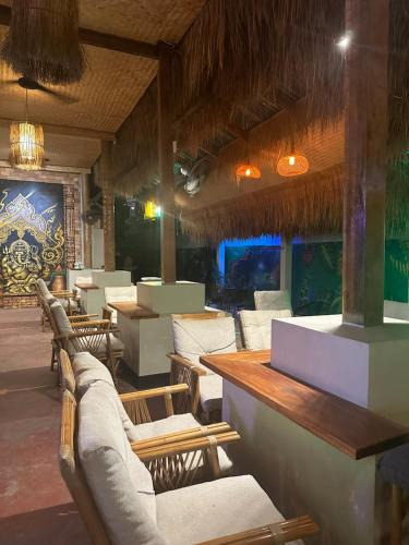 a restaurant with chairs and tables and a bar at Noahs Ark in Amphoe Koh Samui