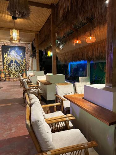 a restaurant with chairs and tables and a bar at Noahs Ark in Amphoe Koh Samui