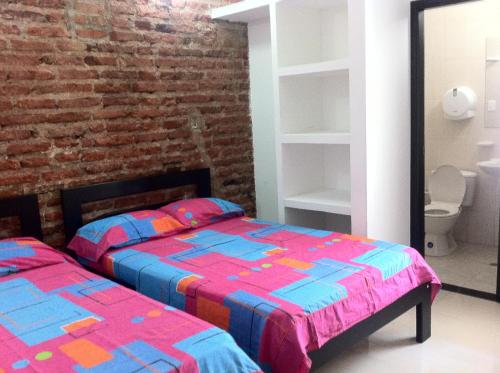 Postel nebo postele na pokoji v ubytování Hotel Cangrejalito