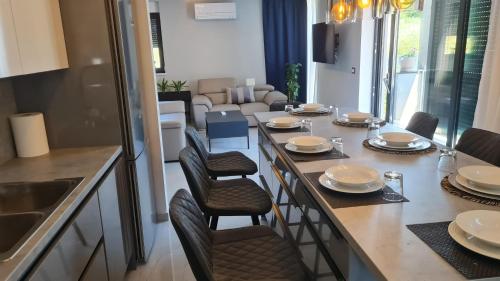 a kitchen with a table and chairs and a living room at VAL22,VILLA 200 m from BEACH WITH POOL AND FITNESS in Funtana