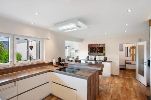 a kitchen with white cabinets and a counter top at Am Wald in Eslohe