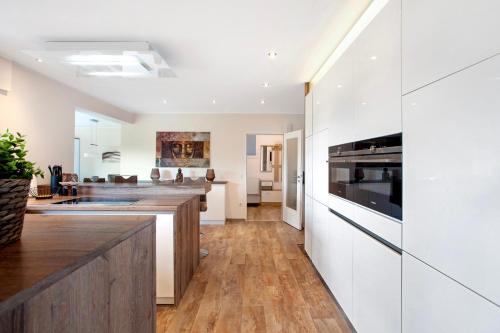a kitchen with white walls and wood flooring at Am Wald in Eslohe