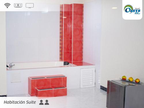 a bathroom with a sink and a tub with red tiles at Hotel Oasys Blue in Roldanillo