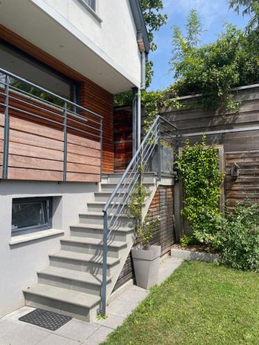 a set of stairs next to a house at Chez L en Alsace Maison indépendante 8 pers Jardin & Cour privative in Griesheim-près-Molsheim