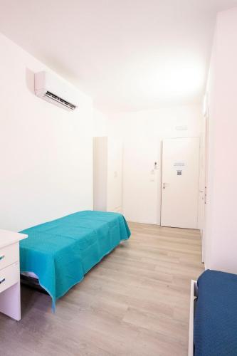 a white room with a bed and a desk at Prestige House 7 in Scalea