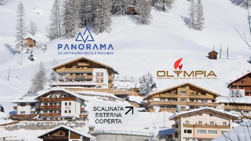 a group of buildings in the snow at Wellness Residence Panorama - check-in at Olympia Hotel in Arabba
