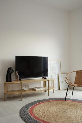 a living room with a flat screen tv on a table at LavandinaLuxe APP in Novi Vinodolski
