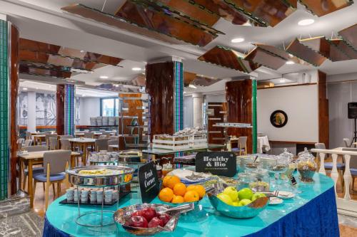 a buffet table with fruit on it in a restaurant at B&B Hotel Chioggia Airone in Sottomarina