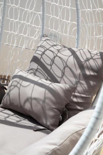 two pillows sitting on a bed with a net at Sunlit Stylish Penthouse with Hot Tub - Close to Sliema Promenade, St Julian's & St Georges Bay in Il-Gżira