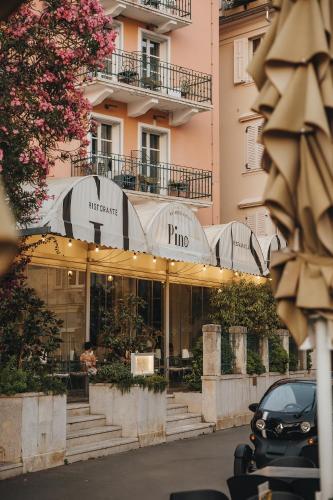 a store in front of a building with a car parked in front at Art Hotel Tartini in Piran
