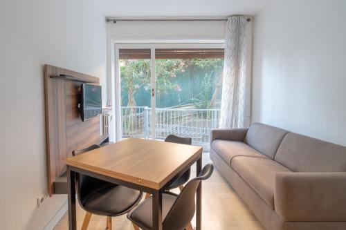 a living room with a couch and a table at E&J Mare e Relax in Sanremo