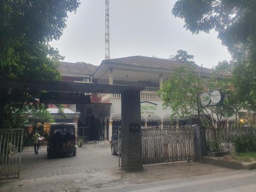 a building with a gate in front of a street at DPalma Bogor by Ruang Tidur in Bogor