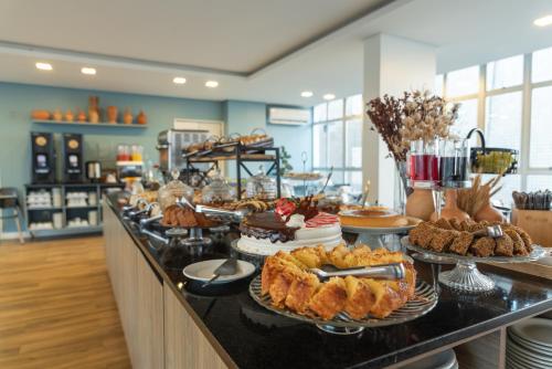 a buffet line with many different types of desserts at Hotel Costamar Ponta Verde in Maceió