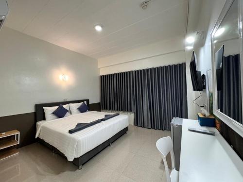 a hotel room with a bed and a television at C4 Resort in Koh Tao