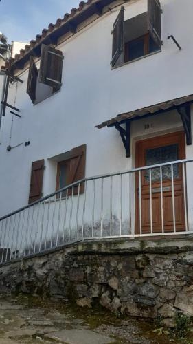 a white building with a balcony and a door at Casa da Ponte Bragança in Bragança