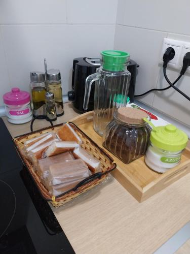 a kitchen counter with a cutting board with jars and a blender at Estancia San Francisco in Calatayud